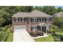 Beautiful brick home with a two-car garage and a manicured front lawn at 704 Millstream Dr, Rock Hill, SC 29732