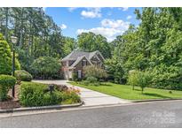 Charming two-story brick home with lush landscaping, long driveway and a well-manicured lawn at 1069 Westlake Dr, Kannapolis, NC 28081