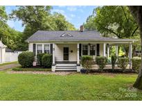 Charming single-Gathering home featuring a quaint front porch, well-maintained landscaping, and inviting curb appeal at 1210 Jackson Rd, Gastonia, NC 28052