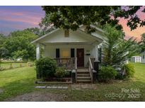 Charming single-story home with a welcoming front porch and well-maintained lawn at 201 Oakland Dr, Lowell, NC 28098