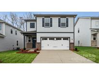 Charming two-story home with gray siding, black shutters, and a two-car garage at 265 Bezelle Ave, York, SC 29745