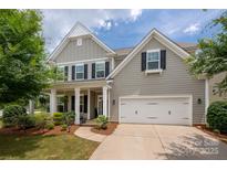 Charming two-story home featuring a two-car garage, inviting front porch and manicured landscaping for excellent curb appeal at 5042 Alston Dr, Lancaster, SC 29720