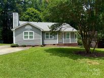 Charming single-story home with a well-maintained lawn and inviting front porch at 6007 Crosswood Ct, Charlotte, NC 28215