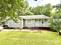 Charming single-story home featuring a cozy front porch, complemented by a well-maintained lawn at 6007 Crosswood Ct, Charlotte, NC 28215
