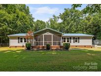 Charming single-story home with a screened-in porch and well-maintained front lawn at 7011 S Providence Rd, Waxhaw, NC 28173