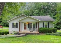 Charming single-story home with a covered front porch, dark shutters and a well-maintained lawn at 704 Willow Rd, Salisbury, NC 28147