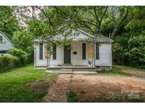 Charming single-story home with white siding and a welcoming front porch at 822 Cantwell St, Charlotte, NC 28208