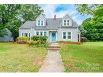 Charming two-story home with a well-maintained lawn and a bright blue front door at 904 Venus St, Kannapolis, NC 28083