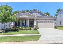 Charming single-Gathering home with a well-manicured lawn, lovely front porch, and attached two-car garage at 9541 Festival Way, Charlotte, NC 28215