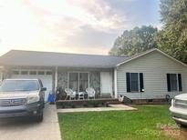 Charming single-story home with stone accents and a well-maintained front lawn at 1250 Landsdowne Dr, Conover, NC 28613