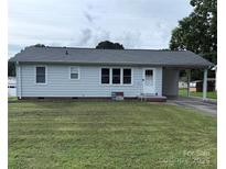 Inviting single-story home with a neatly kept front yard and convenient covered carport at 1314 Hathcock Ave, Albemarle, NC 28001