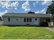 Charming single story home featuring a covered carport and lush front lawn at 1314 Hathcock Ave, Albemarle, NC 28001