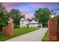 Stunning new construction home with a large front yard and modern design elements at 16112 Terry Ln, Huntersville, NC 28078