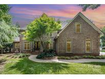 Charming brick home with a manicured lawn, lush landscaping, and inviting front entrance at 174 Hickory Hill Rd, Mooresville, NC 28117