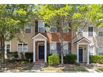 Inviting townhouse featuring a brick facade, neutral siding and classic black shutters at 212 Township Dr, Fort Mill, SC 29715