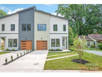 Modern townhome featuring varied siding, complemented by a well-manicured lawn and an attached garage at 2733 Cowles Rd, Charlotte, NC 28208