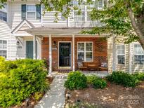 Charming townhome with a brick facade, covered porch, and inviting curb appeal at 3414 Broadwick St, Charlotte, NC 28213
