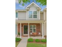 Inviting front porch with brick accents, cozy seating, and manicured landscaping at 3414 Broadwick St, Charlotte, NC 28213