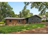 Charming brick home with a well-manicured lawn and mature trees in a serene neighborhood at 3701 Table Rock Rd, Charlotte, NC 28226