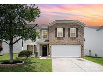 Charming two-story home with brick accents, a well-maintained lawn, and a beautiful tree in the front yard at 4068 Sherri Ln, Fort Mill, SC 29715