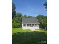 Charming home featuring a welcoming front porch with white railings and a well-maintained lawn at 608 Sharon Dr, Statesville, NC 28625