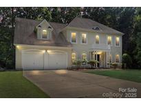 Charming traditional home with a two-car garage, manicured lawn, and covered front entrance at 7151 Plough Dr, Mint Hill, NC 28227