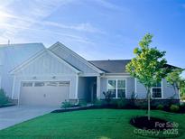 Charming single-story home with manicured lawn, two-car garage, and inviting curb appeal at 11031 Larkslea Ln, Charlotte, NC 28278
