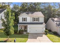 Charming two-story home featuring a two-car garage and a combination of stone and siding at 2532 Blue Moss Dr, Dallas, NC 28034