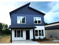 Charming two-story home featuring a modern two-tone exterior and a welcoming front porch at 258 Lincoln Sw St, Concord, NC 28025