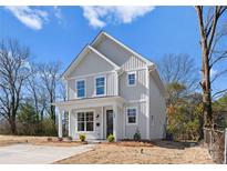 Charming two-story home featuring a welcoming front porch and modern architectural details at 318 Sixth St, Belmont, NC 28012