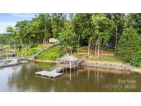 Stunning lake house featuring a private dock with gazebo and lush green surroundings at 360 Lake Landing Dr, Salisbury, NC 28146