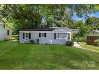 Charming single-story home with painted brick, black shutters, and a well-maintained lawn at 4413 Tillman Rd, Charlotte, NC 28208