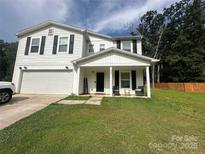 Charming two-story home features a welcoming front porch and a well-manicured lawn at 473 Wendover Dr, Salisbury, NC 28147