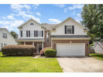 Charming two-story home with a well-manicured lawn, brick accents and a two car garage at 4835 Chesney Nw St, Concord, NC 28027