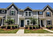 Charming townhome featuring a well-maintained front yard with lush landscaping and a welcoming entrance at 8388 Waxhaw Hwy, Waxhaw, NC 28173