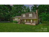 Charming home featuring a brick exterior, well-manicured lawn, and mature trees at 121 Pelham Ln, Fort Mill, SC 29715