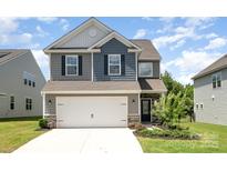 Two-story home with a two-car garage and landscaping at 12912 Canterbury Castle Dr, Charlotte, NC 28273