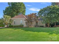 Charming one-story home with a manicured lawn, mature trees, and a welcoming entrance at 15724 Eagleview Dr, Charlotte, NC 28278