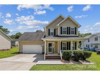 Charming two-story home with a welcoming front porch, attached garage, and well-manicured lawn under a sunny sky at 2040 Brantley Creek Dr, Kannapolis, NC 28083