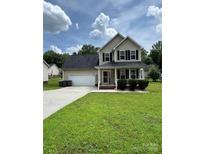Charming two-story home with a well-manicured lawn and inviting front porch at 2040 Brantley Creek Dr, Kannapolis, NC 28083