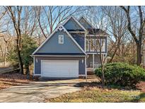 Charming two-story home with a two-car garage and covered front porch in a neighborhood setting at 6017 Millbury Ct, Charlotte, NC 28211