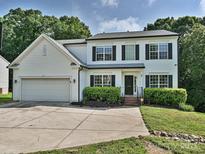 Charming two-story home with a two-car garage, landscaped yard, and classic architectural details at 7309 Rock Hampton Ct, Harrisburg, NC 28075