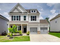 Beautiful two-story home featuring gray siding, brick accents, and a well-manicured front yard at 972 Von Buren Blvd # 242, Rock Hill, SC 29730