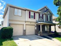 Charming two-story home featuring a two-car garage and inviting front porch at 107 Ameena Chase Trl, Mooresville, NC 28117