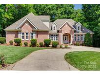 Beautiful brick home with manicured lawn and a curved driveway leading to the front entrance at 125 Highland Forest Dr, Clover, SC 29710