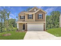 Inviting two-story home with attached two-car garage, manicured lawn, and a classic facade at 136 Dorian Pl, Troutman, NC 28166