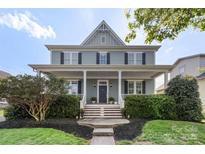 Charming two-story home featuring a welcoming front porch and manicured landscaping at 17327 Summers Walk Blvd, Davidson, NC 28036