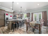 A spacious kitchen with stainless steel appliances, a large island, and an adjacent dining area at 1870 Hwy 49 None, New London, NC 28127