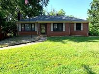 Charming brick home featuring a well-manicured lawn and inviting curb appeal at 209 8Th Nw Ave, Hickory, NC 28601