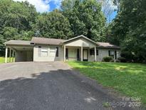 Charming single-story home with a well-maintained lawn, long driveway, and inviting front porch at 227 James Rd, Taylorsville, NC 28681